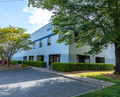 Side view of a white commercial building, sunny day